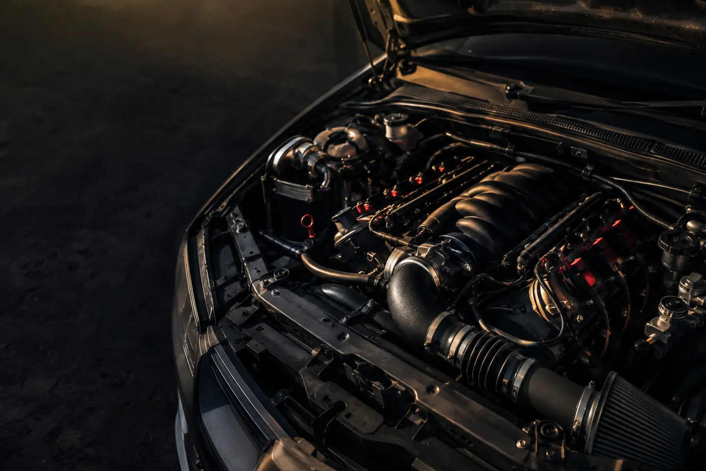 Illustrative view of engine components beneath an open car hood